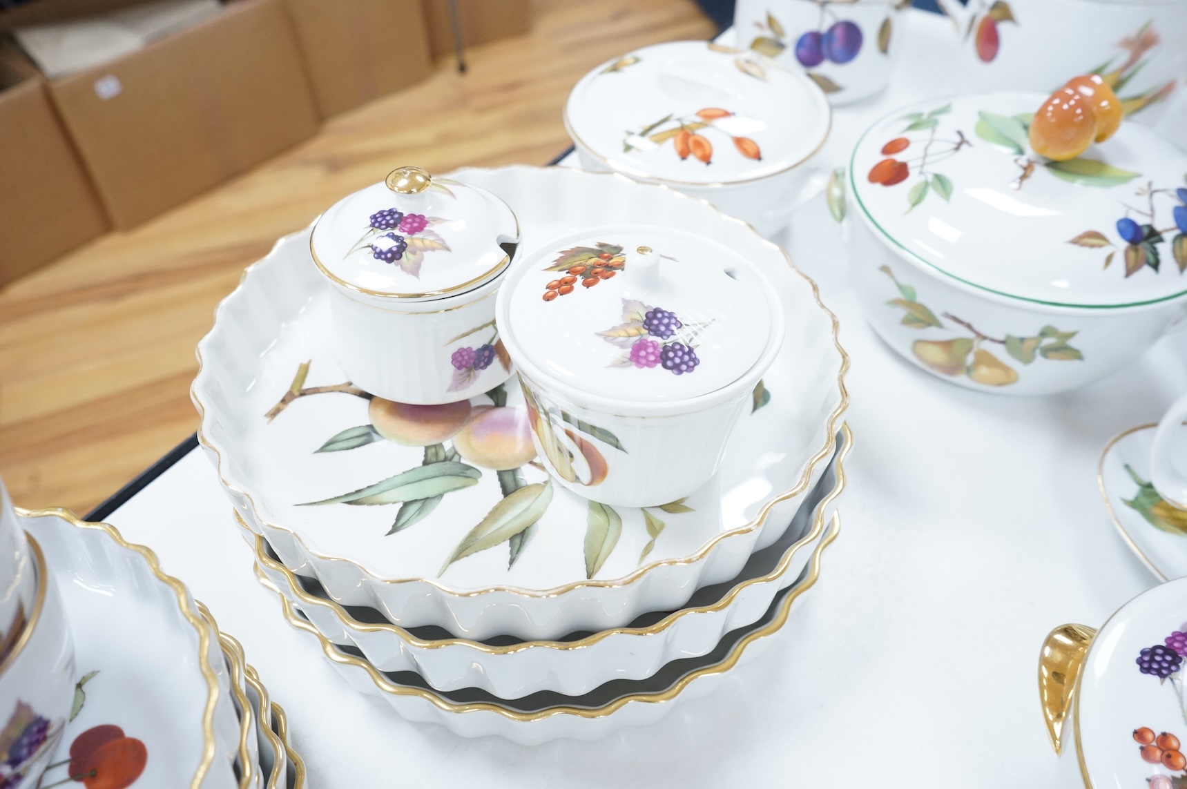 A collection of Royal Worcester Evesham tea and kitchen wares, including storage jars, casserole dishes and cover, flan dishes, serving dishes, tea cups and saucers etc.